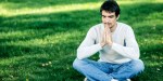 MAN MEDITATING IN PARK