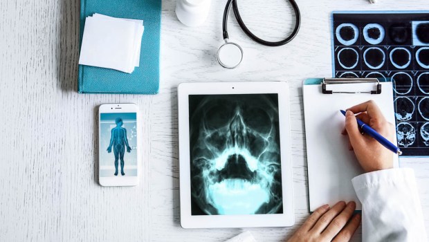 DOCTOR WITH IPAD AND CHARTS