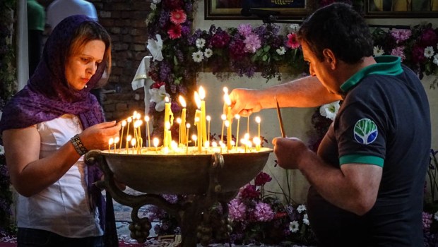 WOMAN LIGHTING CANDLE