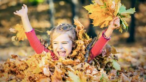 Child Playing in Leaves