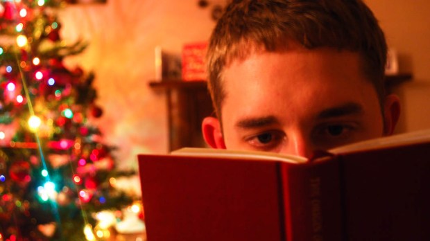 MAN READING,CHRISTMAS TREE