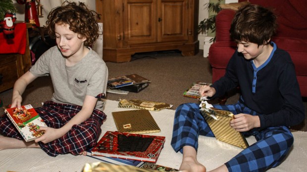 CHILDREN OPENING CHRISTMAS GIFTS