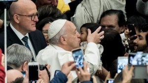 Pope Francis kisses a child