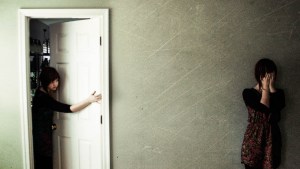 GIRL IN HALLWAY,GIRL LOOKING OUT OF DOOR