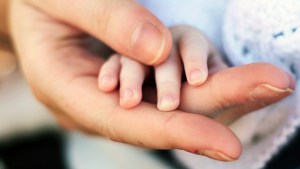 PARENT HOLDING CHILD'S HAND