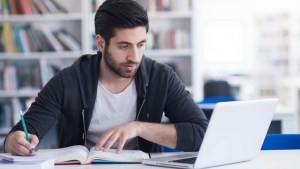 MAN USING HIS COMPUTER