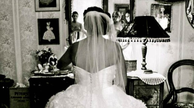 BRIDE LOOKING INTO MIRROR