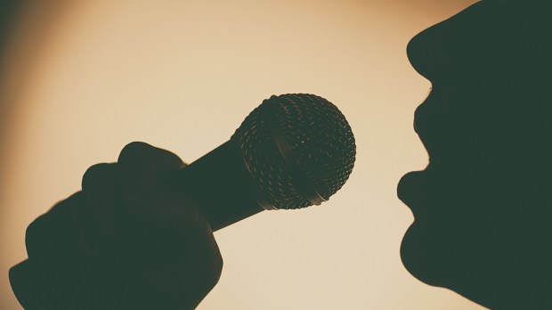 SINGING INTO MICROPHONE