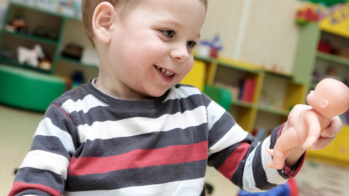 BOY PLAYING WITH DOLL