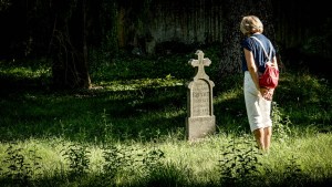 WOMAN VISITING GRAVE