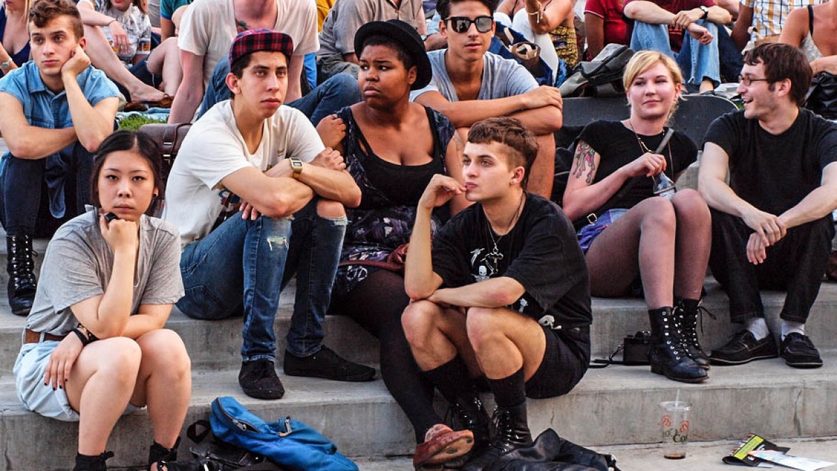 YOUNG ADULTS SITTING ON STEPS