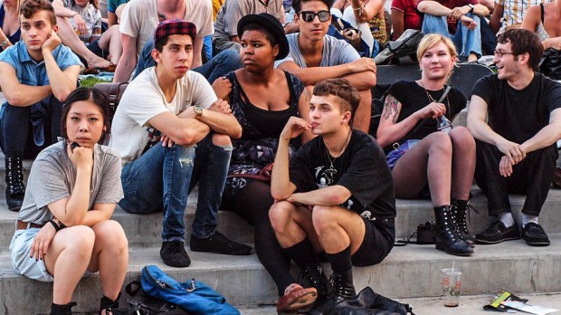 YOUNG ADULTS SITTING ON STEPS