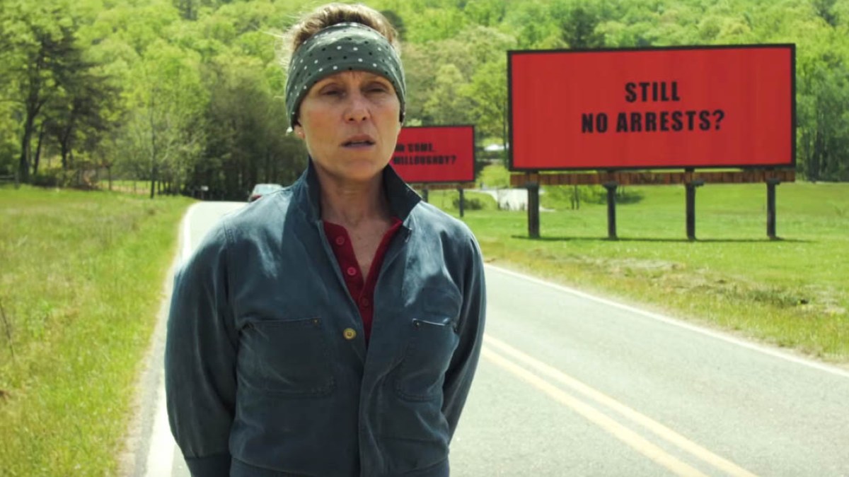 WOMAN STANDING IN FRONT OF BILLBOARD