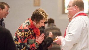 WOMAN,PRIEST,COMMUNION