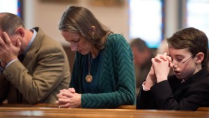 PEOPLE PRAYING IN CHURCH