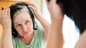 WOMAN LOOKING IN MIRROR