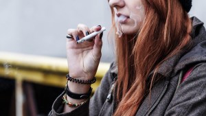 WOMAN,OUTSIDE,SMOKING,CIGARETTE