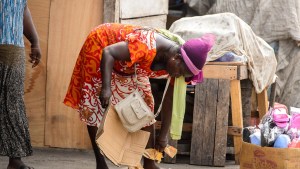 AFRICAN,WOMAN,BENDS,OVER