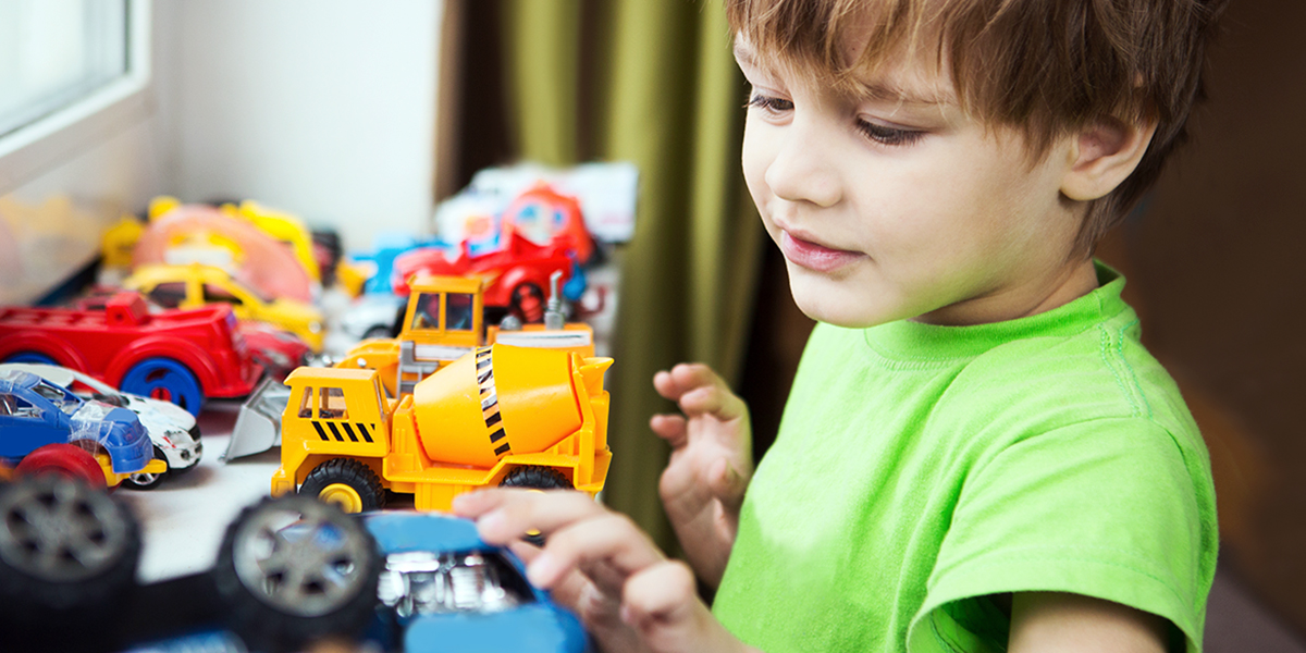 BOY PLAYING WITH CARS