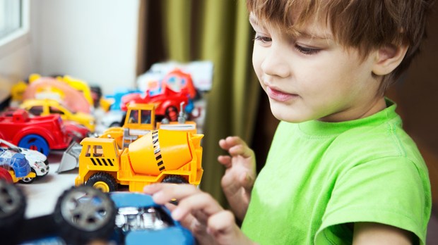 BOY PLAYING WITH CARS