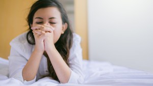 WOMAN PRAYING ON THE BED