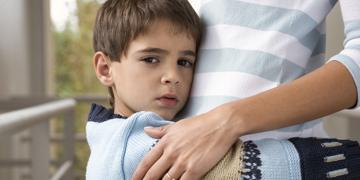 BOY HUGGING MOTHER