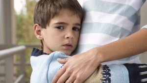 BOY HUGGING MOTHER