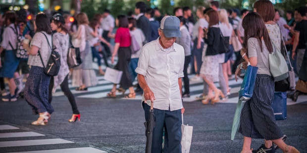 MAN CROSSING THE SHIBUYA SCRAMBLE