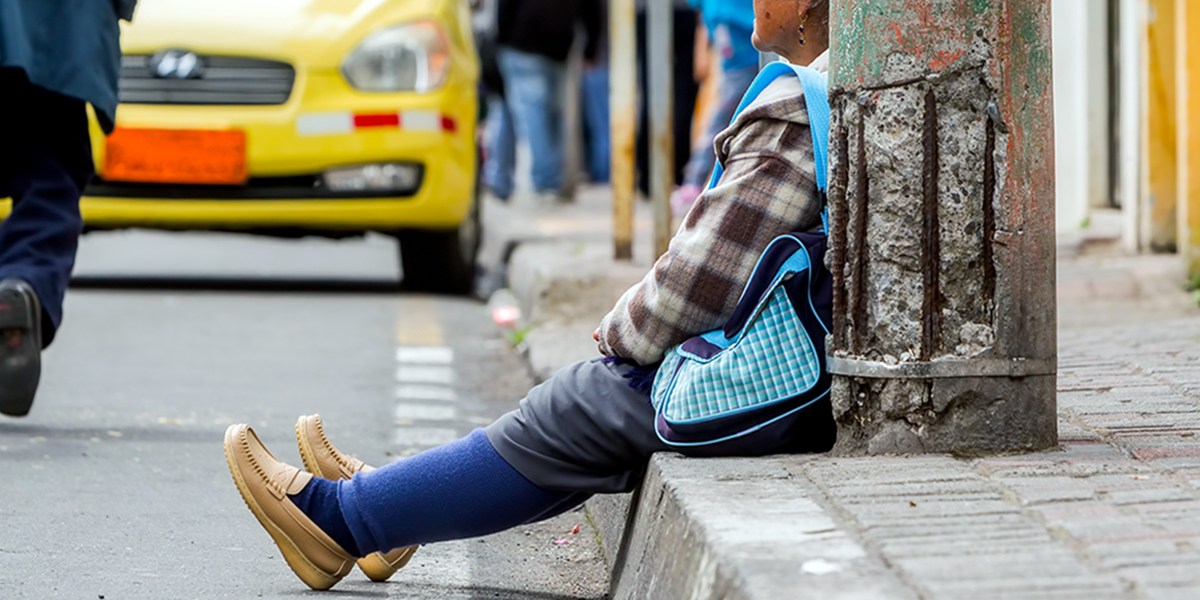 ELDERLY WOMAN ON SIDEWALK