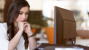 WOMAN SITTING AT DESK