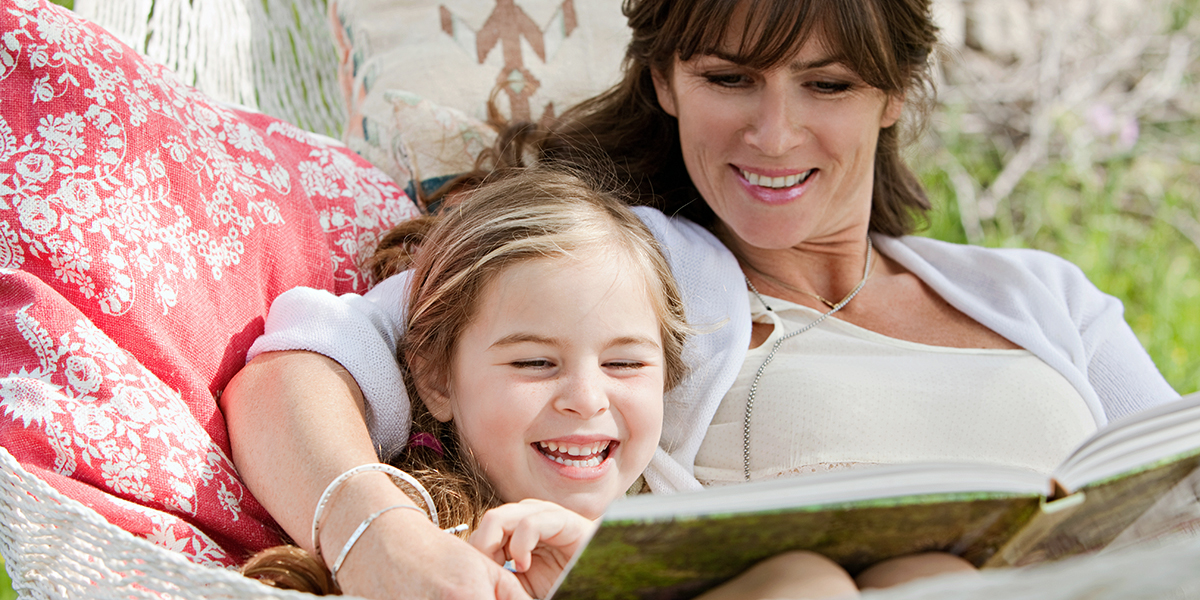 MOTHER READING TO DAUGHTER