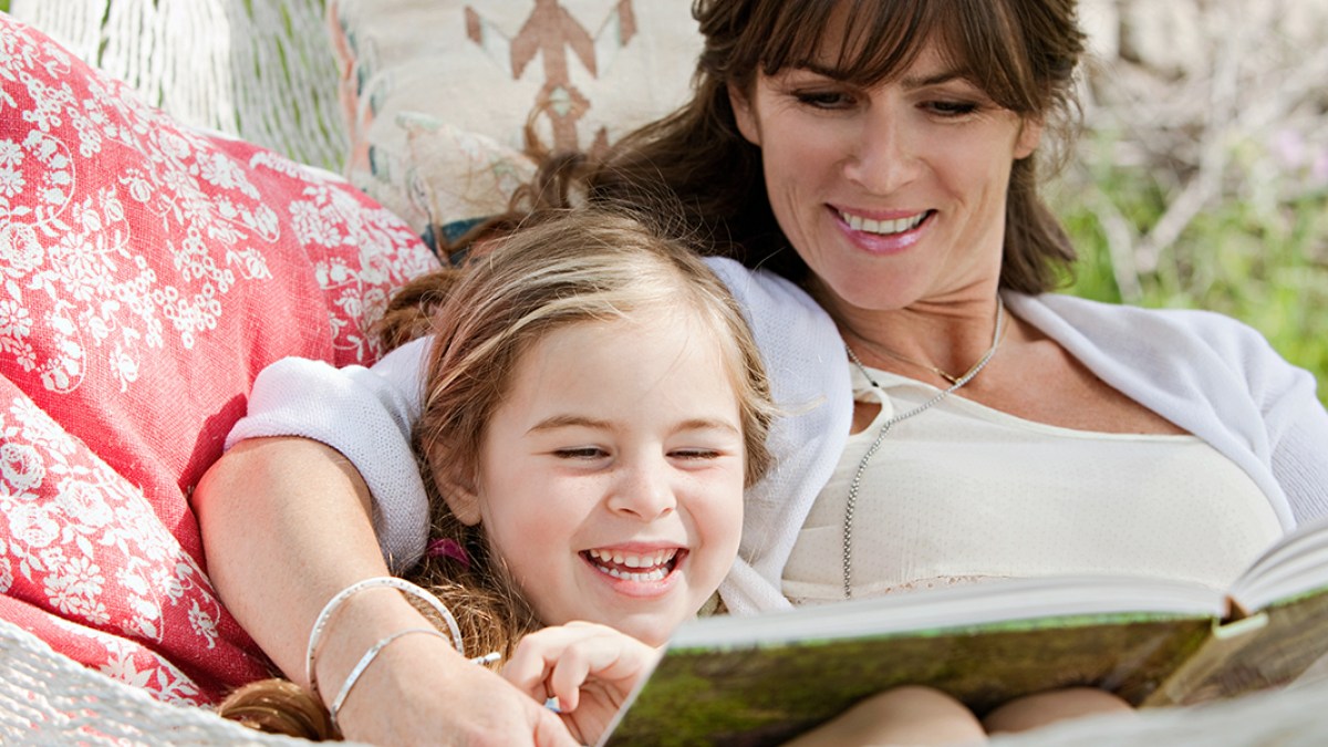 MOTHER READING TO DAUGHTER