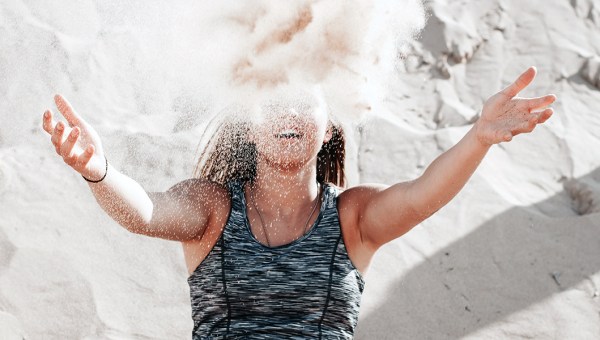 WOMAN THROWING SAND