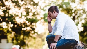 MAN,PRAYING,OUTSIDE