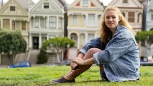 YOUNG GIRL,SITTING ON GRASS