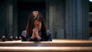 WOMAN PRAYING,CHURCH PEWS