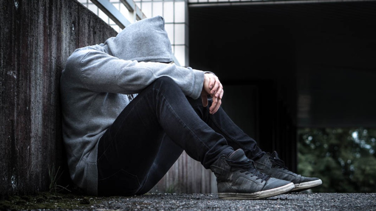 MAN SITTING,HEAD DOWN