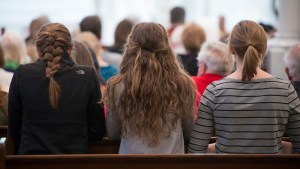 Young Woman Praying at Mass