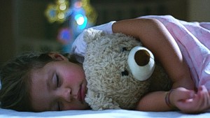 Little girl sleeping with teddy bear