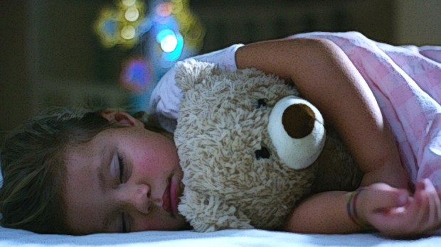 Little girl sleeping with teddy bear