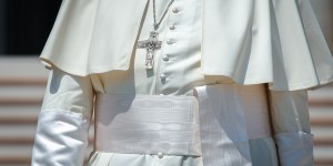 Why does the pope wear a white sash around his waist?