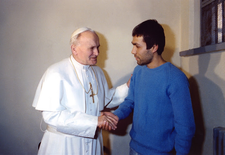 Pope John Paull II shaking hands with his would-be assassin, Mehmet Ali Agca