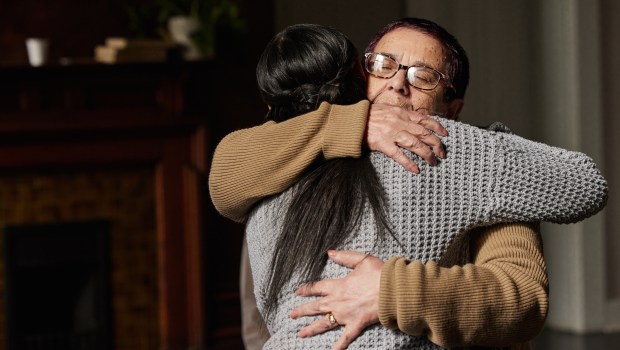 older woman hugging younger woman