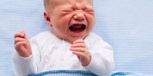 During COVID restrictions an Irish policeman helps parents traveling with a fussy baby