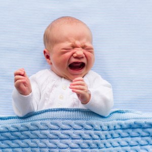 During COVID restrictions an Irish policeman helps parents traveling with a fussy baby