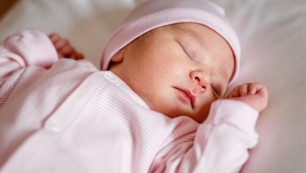 Sleeping baby wearing pink