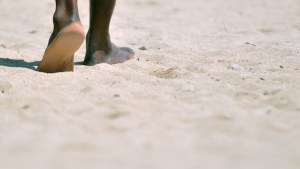 feet walking in sand