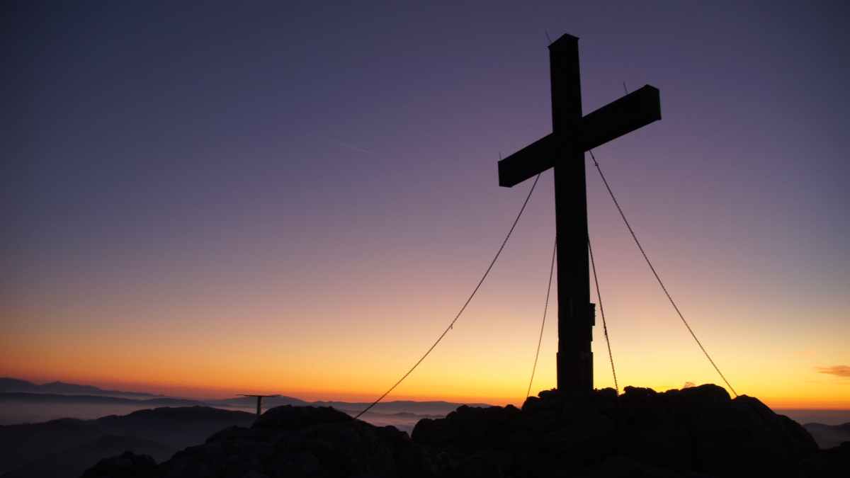 cross silhouette during golden hour