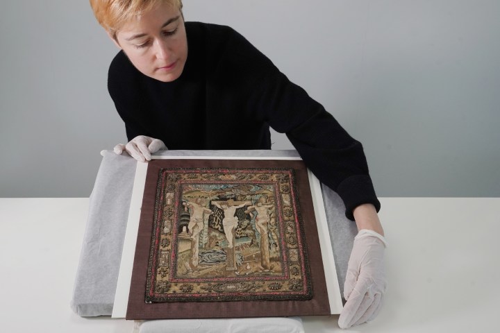 Helen-Wyld-Senior-Curator-of-Historic-Textiles-at-National-Museums-Scotland-with-the-17th-century-embroidery.-Photo-©-Stewart-Attwood-2.jpg