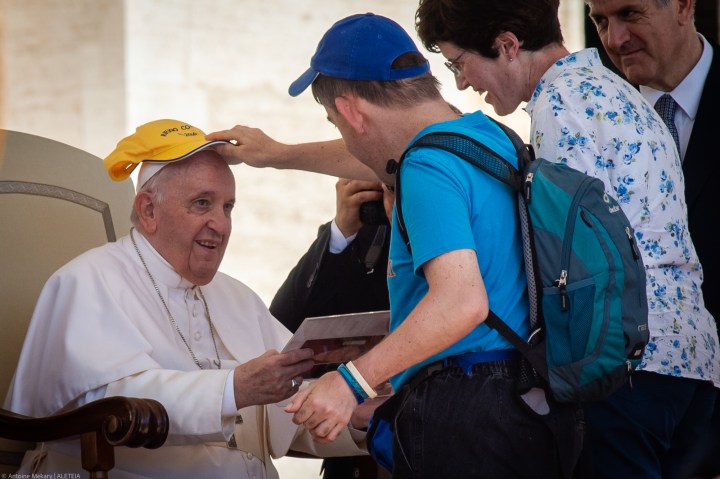The heart is like a good wine, says Pope: The older the better 2 a man puts a hat on Pope Francis had